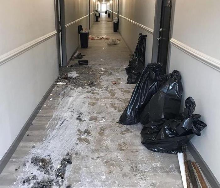 A photo of an apartment complex hallway after fire extinguishers had been used to extinguish a fire in an apartment.