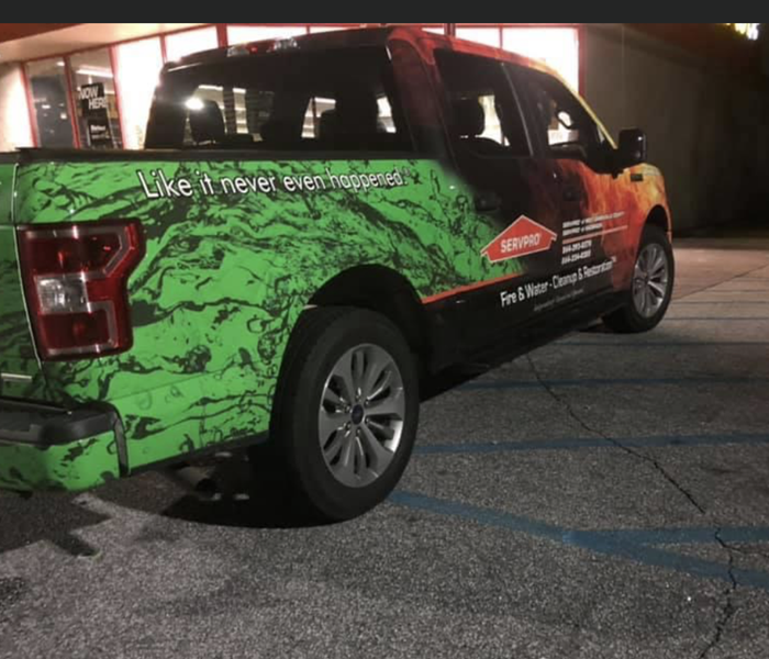 SERVPRO pickup truck parked outside of commercial building that production was cleaning