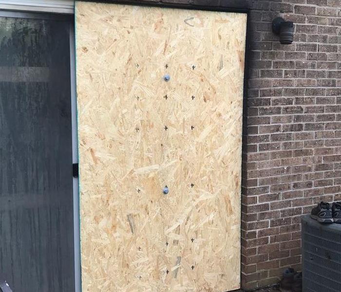 sliding door boarded up to prevent reentry 