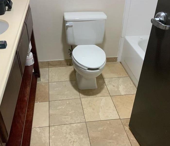 toilet in hotel bathroom that caused water damage