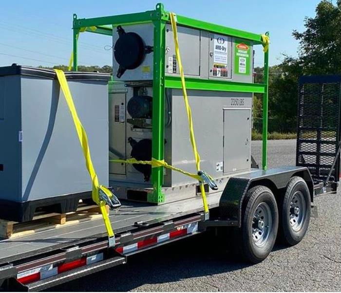 photo of commercial grade desiccant dehumidifier strapped to back of long bed truck. 